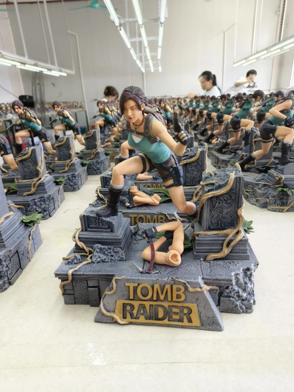 A production team finishing Lara Croft statues in a manufacturing workshop, from Bigshot Toyworks’ portfolio.