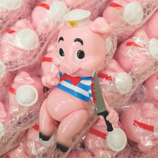 Pink vinyl character edition surrounded by wrapped production units, from Bigshot Toyworks’ portfolio.